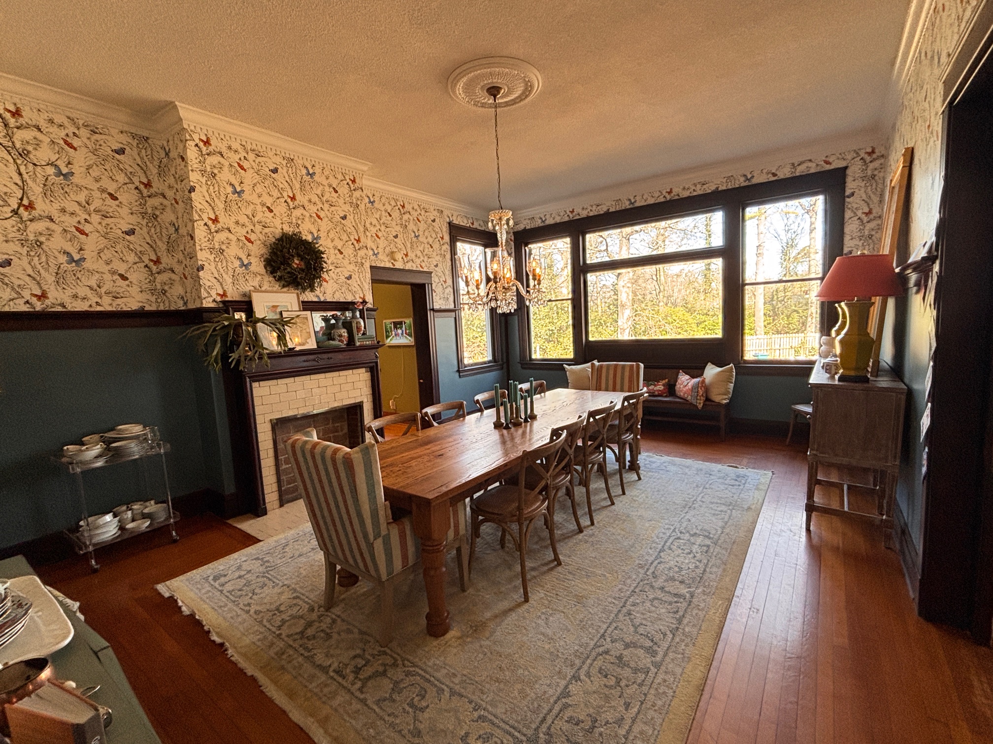 Dining room with fireplace and large farmhouse table at The Franklin House